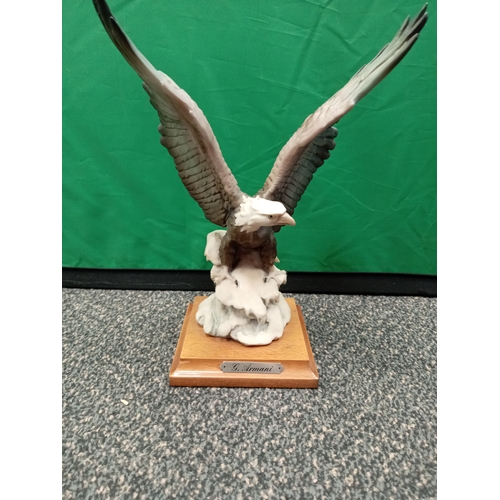 678 - Giuseppe Armani 'Eagle on snow' #175 C retired figurine. On a mahogany wood stand.