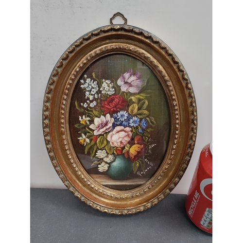 685 - An antique Ornate oval framed still life oil painting of flowers in a vase. Signed. H 23cm x W 18cm