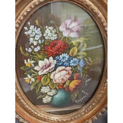 685 - An antique Ornate oval framed still life oil painting of flowers in a vase. Signed. H 23cm x W 18cm