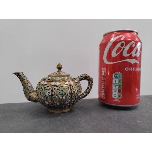 692 - A miniature cloisonne teapot with oriental pattern. H 6cm x 12cm.