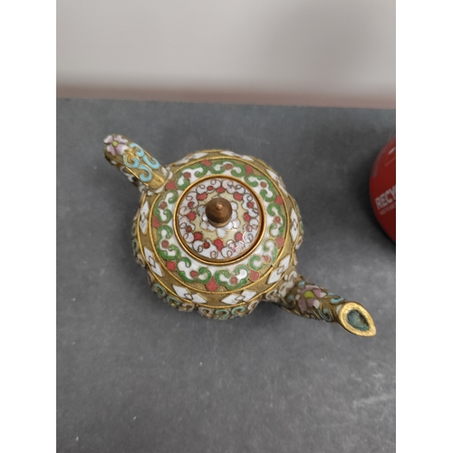 692 - A miniature cloisonne teapot with oriental pattern. H 6cm x 12cm.