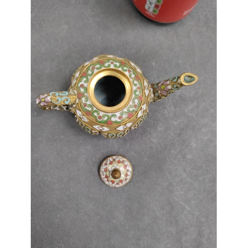 692 - A miniature cloisonne teapot with oriental pattern. H 6cm x 12cm.