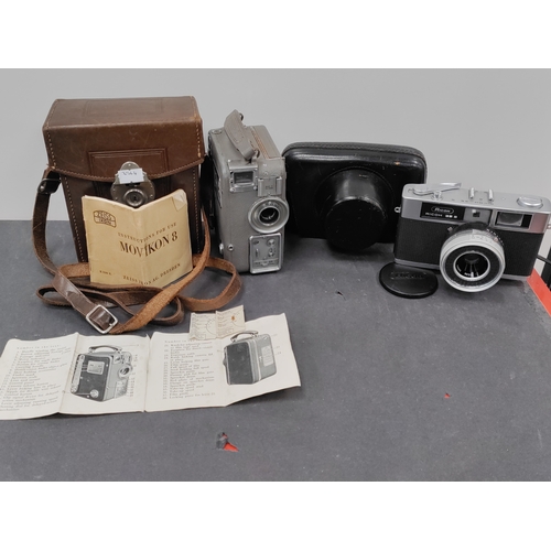 726 - Two vintage cameras. One is a Movikon 8 with original box and manuals and the other is a Ricoh 35 S ... 