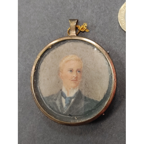 722 - An original Victorian hand painted portrait of a man in a small circular frame.