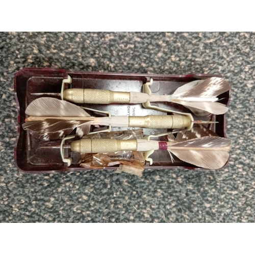 696 - Vintage unicorn brass and feather Darts, in original bakelite case, this includes spare points.