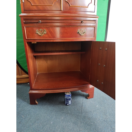 106 - A vintage TV / drinks cabinet with a pull out flap and draw fronted cupboard. Includes keys.