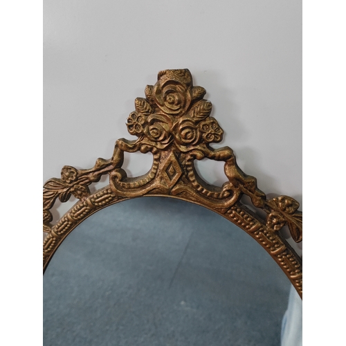 109 - A vintage ornate gold gilt frame wall mirror. H 68cm x 35cm.