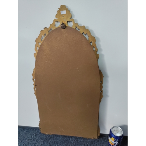 109 - A vintage ornate gold gilt frame wall mirror. H 68cm x 35cm.