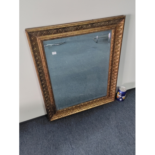 114 - A vintage gold gilt framed bevelled edge mirror. H 63cm x W 53cm.