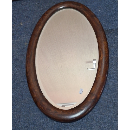 106 - Large vintage dark Oak oval mirror, measures H69cm x 41cm. AF
