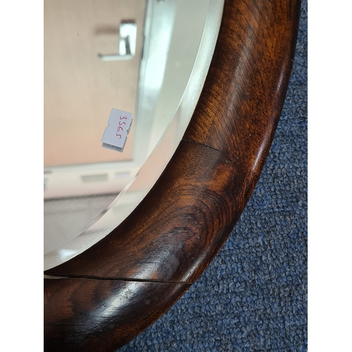106 - Large vintage dark Oak oval mirror, measures H69cm x 41cm. AF