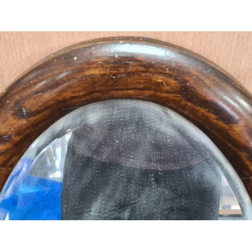 106 - Large vintage dark Oak oval mirror, measures H69cm x 41cm. AF