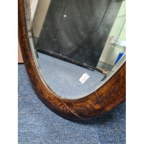 106 - Large vintage dark Oak oval mirror, measures H69cm x 41cm. AF