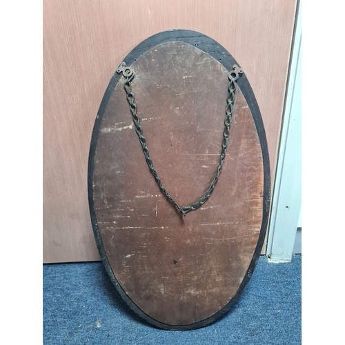 106 - Large vintage dark Oak oval mirror, measures H69cm x 41cm. AF