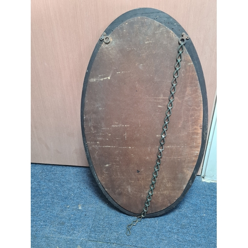 106 - Large vintage dark Oak oval mirror, measures H69cm x 41cm. AF