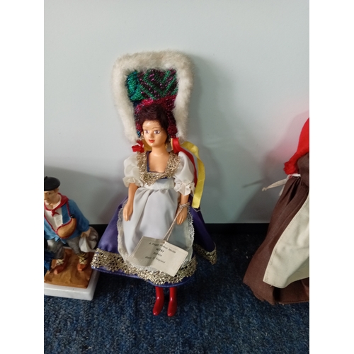 83 - A collection of vintage dolls, two porcelain costume dolls, one by Peggy Nisbet. Two Greek boxed dol... 