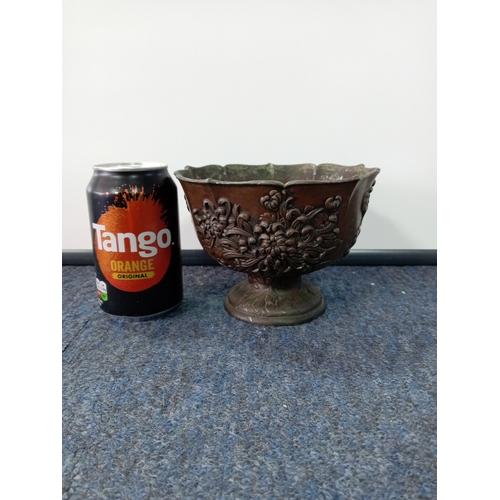 85 - An Oriental coppered bronze pedestal bowl with a blossom detail.