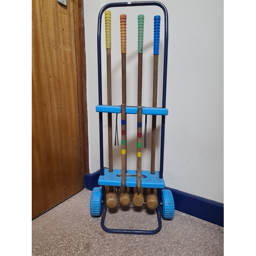 144 - Vintage 4 player garden Croquet set. Measures H86cm x W35cm x 20cm.