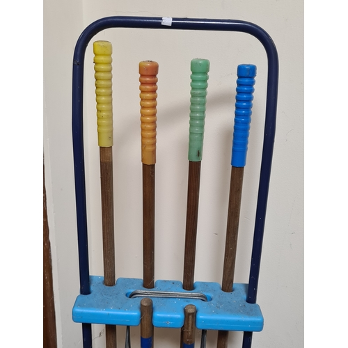 144 - Vintage 4 player garden Croquet set. Measures H86cm x W35cm x 20cm.
