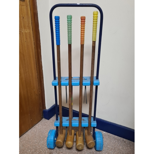 144 - Vintage 4 player garden Croquet set. Measures H86cm x W35cm x 20cm.