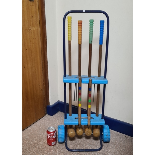 144 - Vintage 4 player garden Croquet set. Measures H86cm x W35cm x 20cm.