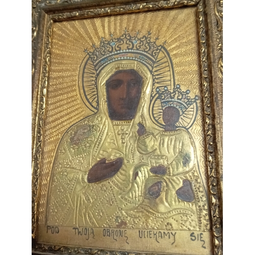 252 - An antique handpainted religious icon of The Black Madonna of Czestochowa Poland in a gold gilt fram... 