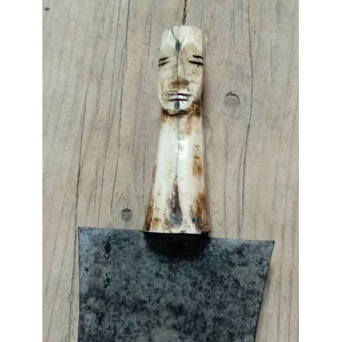 8 - An antique carved bone handled nieve trowel. H 28cm.