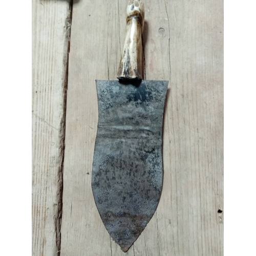 8 - An antique carved bone handled nieve trowel. H 28cm.