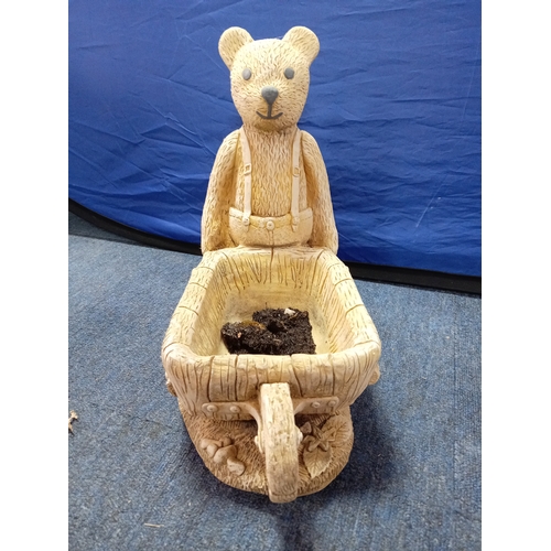 17 - A heavy stone teddy bear pushing a wheel barrow planter