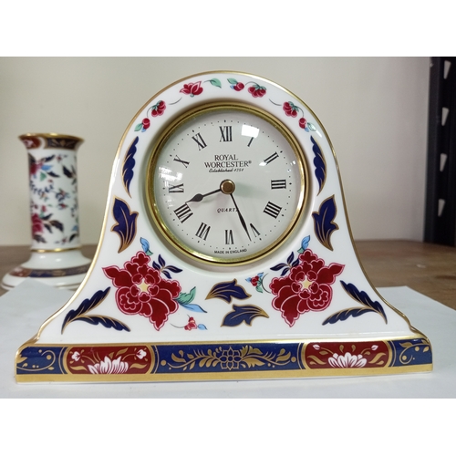 26 - A Royal Worcester ceramic clock and candlestick both with floral design.
