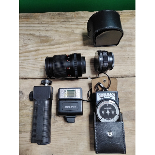30 - A praktica mtl3 camera with spare lenses, clicker, flash attachment and storage bag
