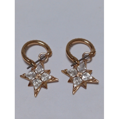 303 - A pair of Swarovski symbolic drop earrings.