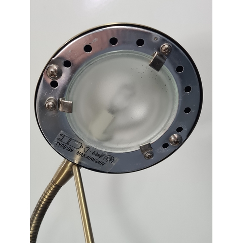 35 - A brass toned desk lamp with adjustable gooseneck light. Max reach 55cm.