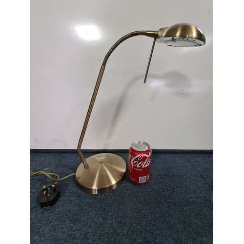 35 - A brass toned desk lamp with adjustable gooseneck light. Max reach 55cm.