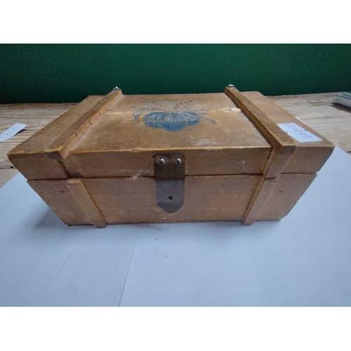 202 - A small wooden box housing a hand painted egg with Japanese lettering.