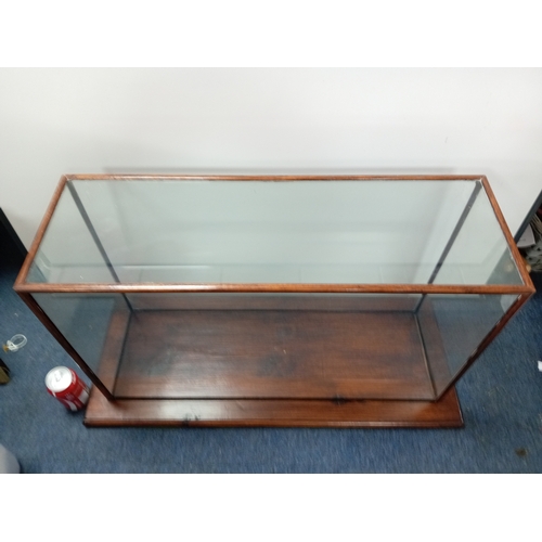206 - A vintage rectangular glass display case which lifts off the wood base. H 49cm x W 86.5cm x D 35cm.