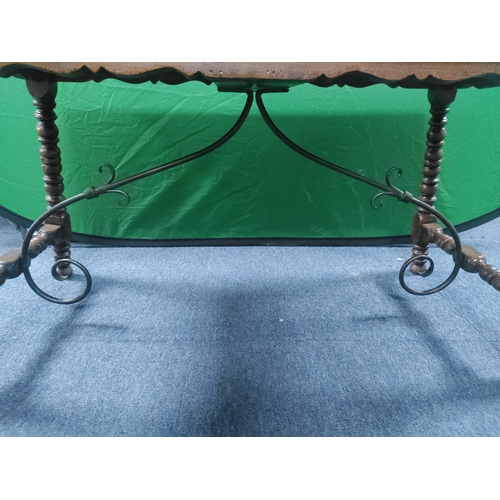 166 - A vintage wooden coffee table with wrought iron supports H 46 cm x D 40cm x W 85cm