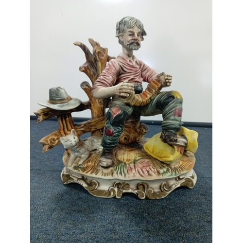 64 - A Capodimonte statue of a man playing accordian H 28 W 30 and a pair of large glass candle holders