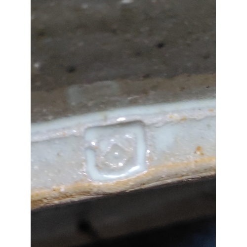 215 - A vintage Colin Kellam studio pottery wall plate decorated with a floral pattern. Diameter 28cm.