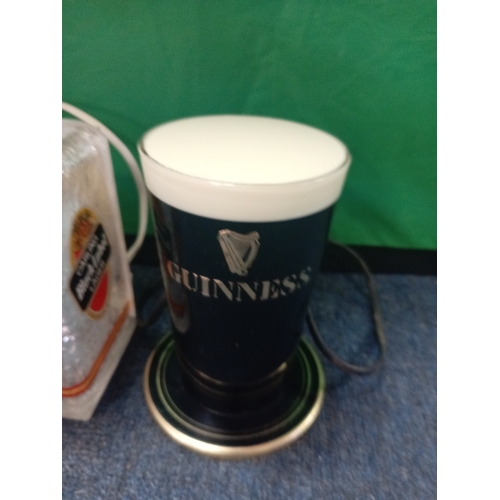 218 - Two vintage bar top fonts. One Carling black label and the other guiness.