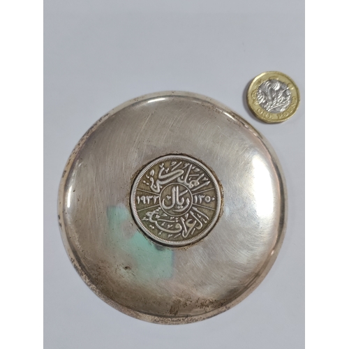 272 - A pair of ashtrays with coins mounted in the centre. One has a silver 1932 Iraq 200 fils and is beli... 