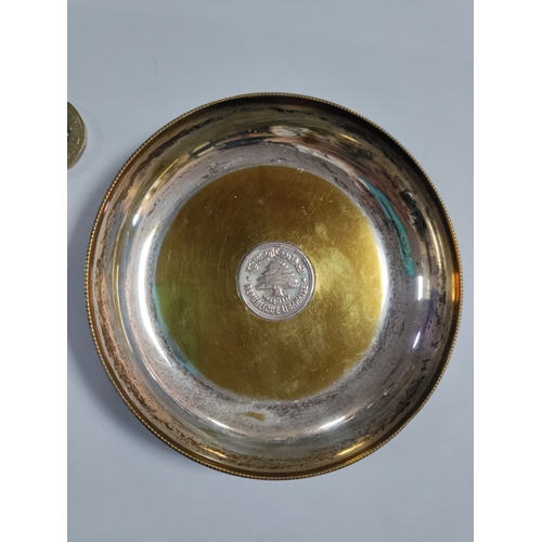 272 - A pair of ashtrays with coins mounted in the centre. One has a silver 1932 Iraq 200 fils and is beli... 
