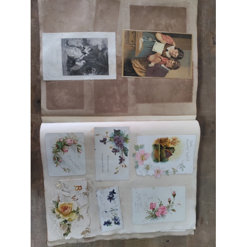 267 - A Victorian to Edwardian album of postcards, greetings cards and photographs.