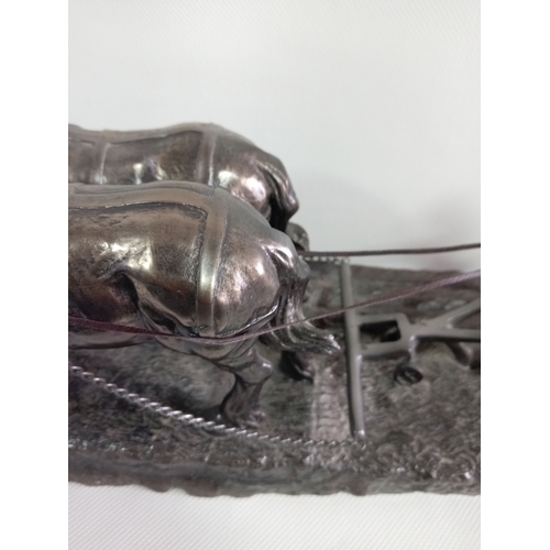 230 - A cold cast bronze sculpture of a ploughman with his horses. A few small repairs to the plough.