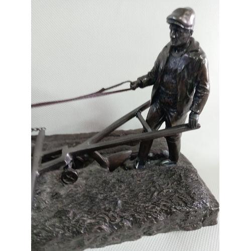 230 - A cold cast bronze sculpture of a ploughman with his horses. A few small repairs to the plough.
