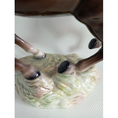 231 - A beswick galloping brown horse. Model no 1374. Small repairs made between hooves and base. Displays... 