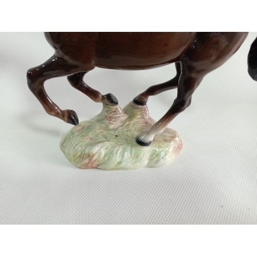 231 - A beswick galloping brown horse. Model no 1374. Small repairs made between hooves and base. Displays... 
