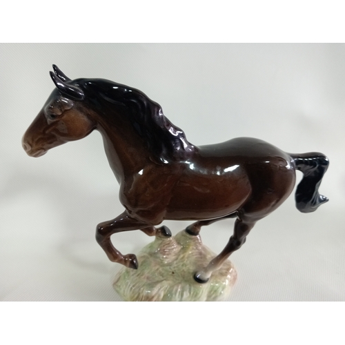 231 - A beswick galloping brown horse. Model no 1374. Small repairs made between hooves and base. Displays... 