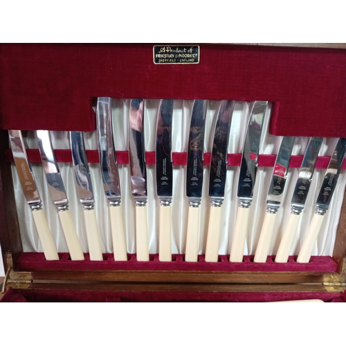 245 - A six service silver plated canteen of cutlery set by Priestly and Moore in an art deco wooden box.