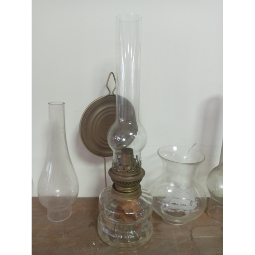 9 - Vintage Clear Glass Oil Lamp With Ornate Base Including An Assortment Of Glass Lamp shades and chimn... 